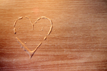 heart drops on a table, love concept on wooden