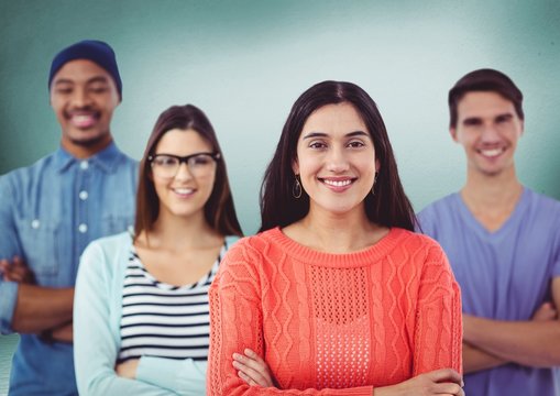 Millennial team smiling against green room