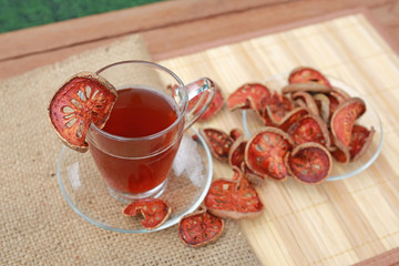 Bael juice and bael dried on wooden plate.