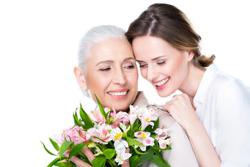 adult daughter and mother with bouquet