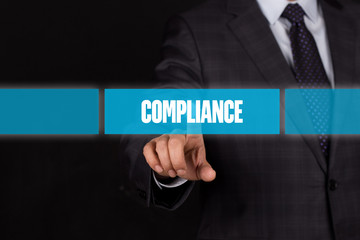 Hand pushing on a touch screen interface-COMPLIANCE button