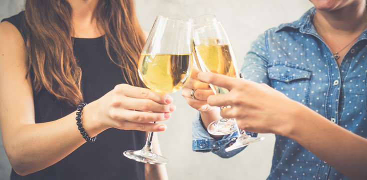 Group of women celebrating in a party, clinking glasses of wine,beer,liquor, spirit, booze with happy and relaxing feeling, party and celebration concept vintage tone