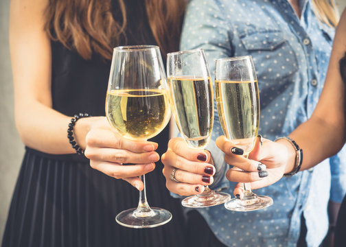 Group of women celebrating in a party, clinking glasses of wine,beer,liquor, spirit, booze with happy and relaxing feeling, party and celebration concept vintage tone