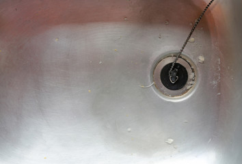 close up on dirty kitchen sink drain.