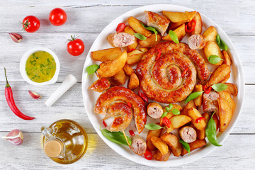hot fried sausages and potato on platter