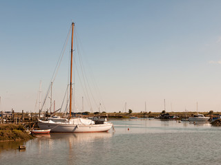 white yacht boat moored in dock of marshland tollesbury maldon