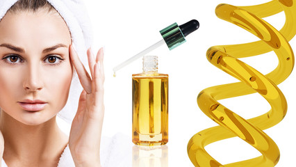 Cosmetic oil applying on face of young woman.