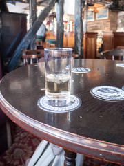 Fototapeta na wymiar glass of white wine on table in pub no people