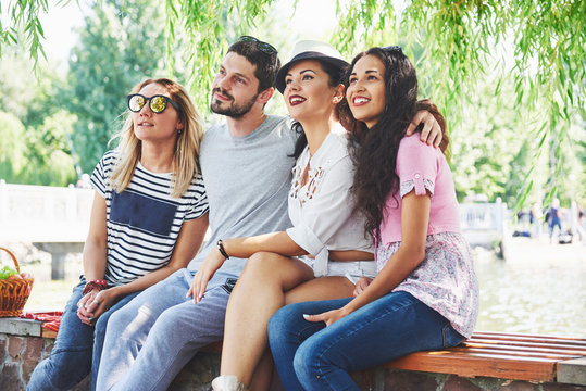 Group of friends relaxing and playing together. Young people chat on the streets, weigh and play games together