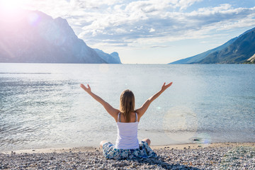 Woman meditating at the lake