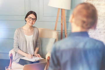 Positive school psychologist going to talk with a teen boy