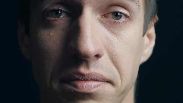 Close up portrait of crying man with tears