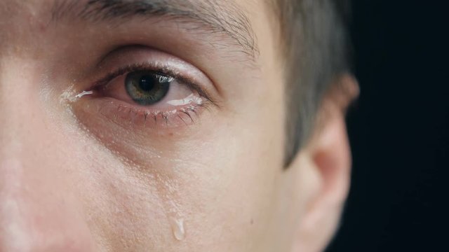 Shot of Crying man with tears in eye closeup