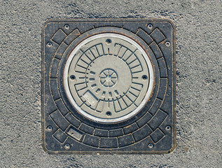 gray hatch in the asphalt