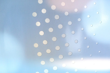 metal texture with circular holes of light blue Abstract background