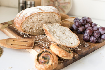  Sliced bread, grape and buns on a cutting board