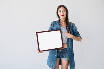 Fototapeta premium Woman with advertising frame 
