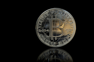 Cryptocurrency physical bitcoin isolated on black