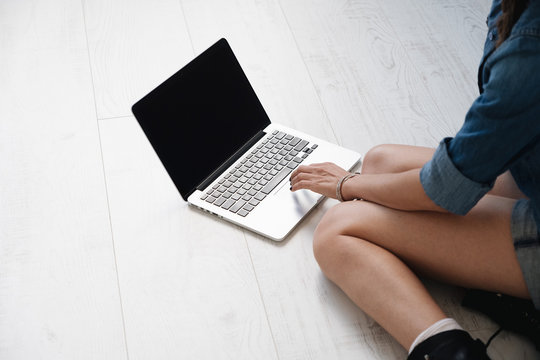 Close-up girl typing on laptop