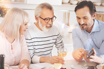 Cheerful friendly family resting at the table