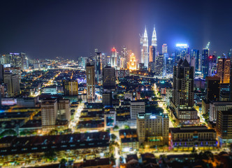 Obraz na płótnie Canvas Cityscape of Kuala Lumpur city skyline at night in Malaysia. Tilt-shift effected photo.