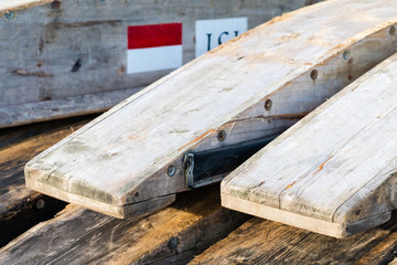 Wooden rafting boats on a pile on the river bank