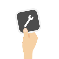 Hand hält graue Karte - Schraubenschlüssel