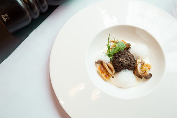 stuffed morels under truffle sauce