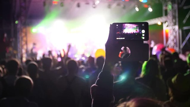 people use smart phones record video at music concert