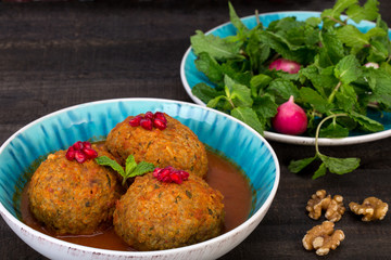 Koofteh Tabrizi Large Meatballs Stuffed With Dried Fruits, Berries And Nuts In Tomato Turmeric Broth A Traditional Azeri And Iranian Dish Served In Turquoise Bowl Garnished With Pomegranate