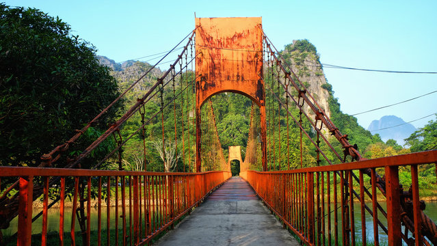 The orange bridge over the Nam Xong (Song River) in Vang Vieng, Laos