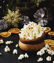 popcorn in a wooden plate on the background of Christmas