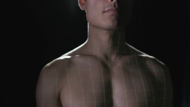  Illuminated heart pulse projected onto the chest of naked male model