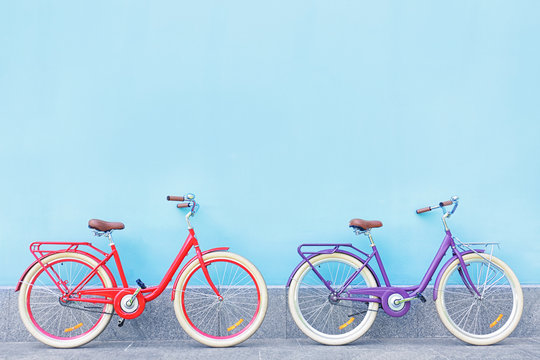Fototapeta Stylish new bicycles near color wall outdoors