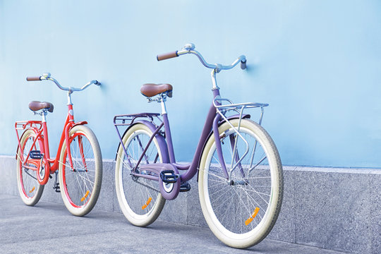 Fototapeta Stylish new bicycles near color wall outdoors