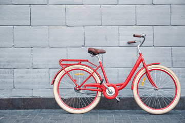 Fototapeta na wymiar Stylish new bicycle near stone wall outdoors
