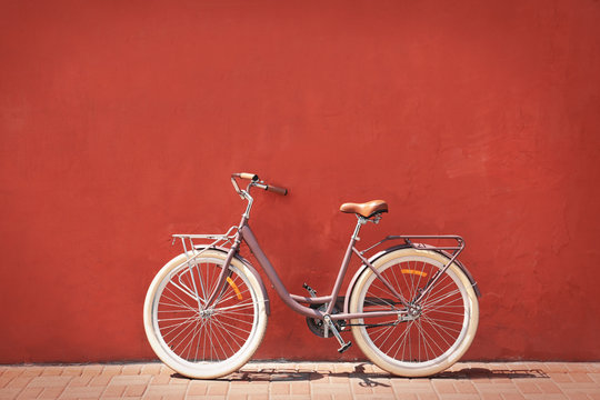Fototapeta Stylish new bicycle near color wall outdoors