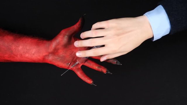 Demon gives a narcotic syringe to a man.