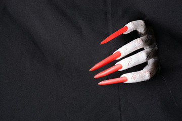 Scary halloween vampire tearing through fabric