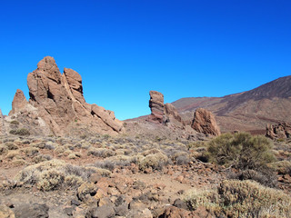 Fototapeta premium mountain and volcanic rock formations in teide national park in tenerife with clear blue sky
