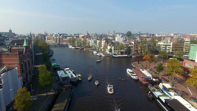 Tourist boats in the canal of Amsterdam, aerial view