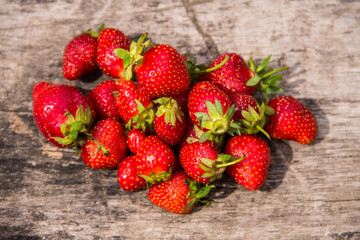 Ripe fresh strawberries on rustic wooden background. Top view