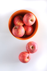 apples on a bowl with light background