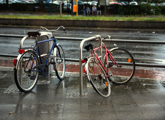 Fototapeta na wymiar bicycles on wet Berlin city street in rain. Rainy day
