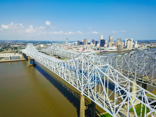 Aerial view of Crescent City Connection and riverside Downtown New Orleans again cloud blue sky....
