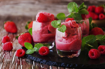 frozen yogurt, sorbet with strawberries, raspberries and mint, selective focus