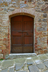 old wooden door in brick wall