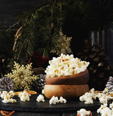 popcorn in a wooden plate on the background of Christmas