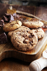Chocolate cookies on wooden table. Chocolate chip cookies shot