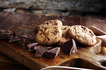 Fototapeta premium Chocolate cookies on wooden table. Chocolate chip cookies shot